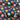 Bright multi-color space planets starburst digital print fabric on blue and black background with thread spools.