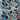 Fabric print featuring Xbox, Playstation, and Nintendo controllers on a blue background with spools of red and blue thread.
