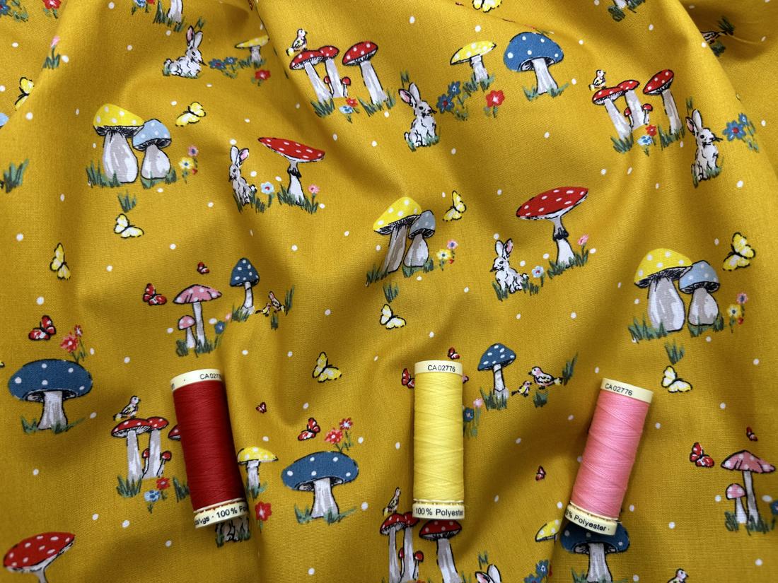 Rabbits Toadstools Butterflies & Birds on a Mustard Background 100% Cotton