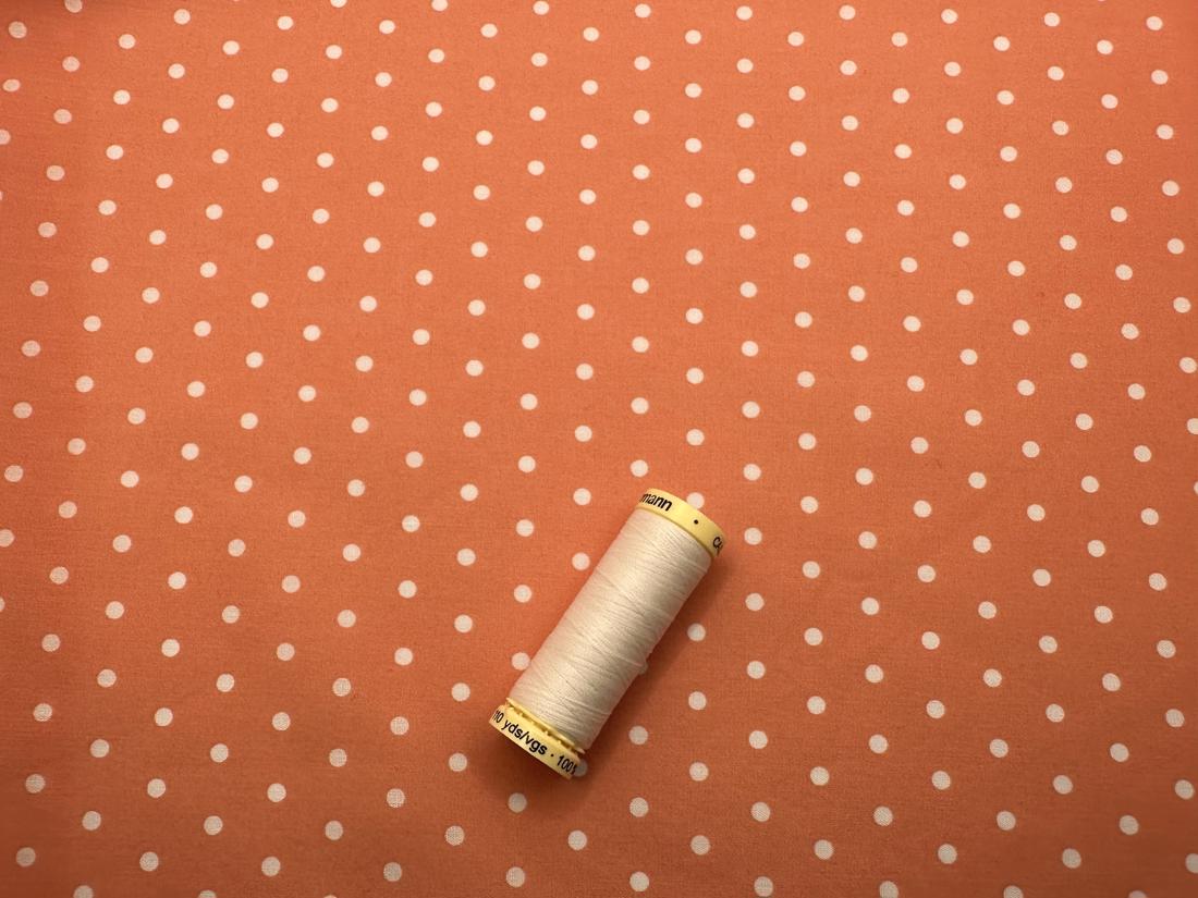 Simple White 3mm Polka Dot on a Peach Background Poly Cotton