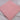 Folded plain candy pink poly cotton fabric piece on white fabric background