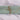 Folded plain mint green cotton fabric tied with natural twine on white cloth background