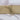 Plain beige 100% cotton fabric rolled and tied with twine on white background