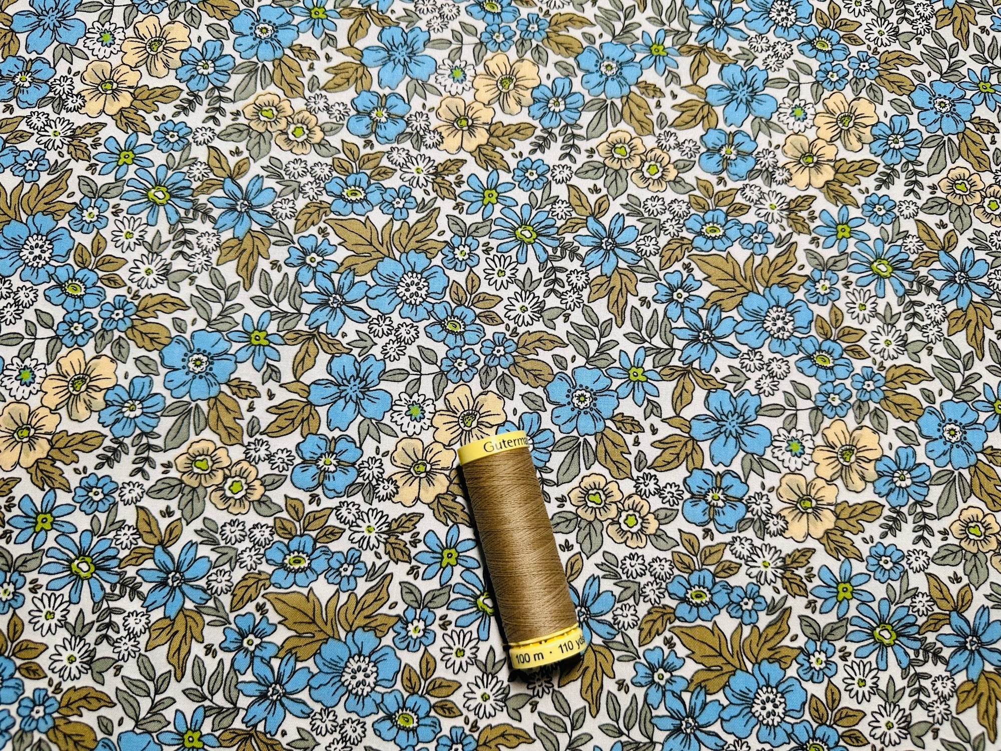 Daisy Floral Mix Surrounded by Leaves Blue on a Ivory Background 100% Cotton