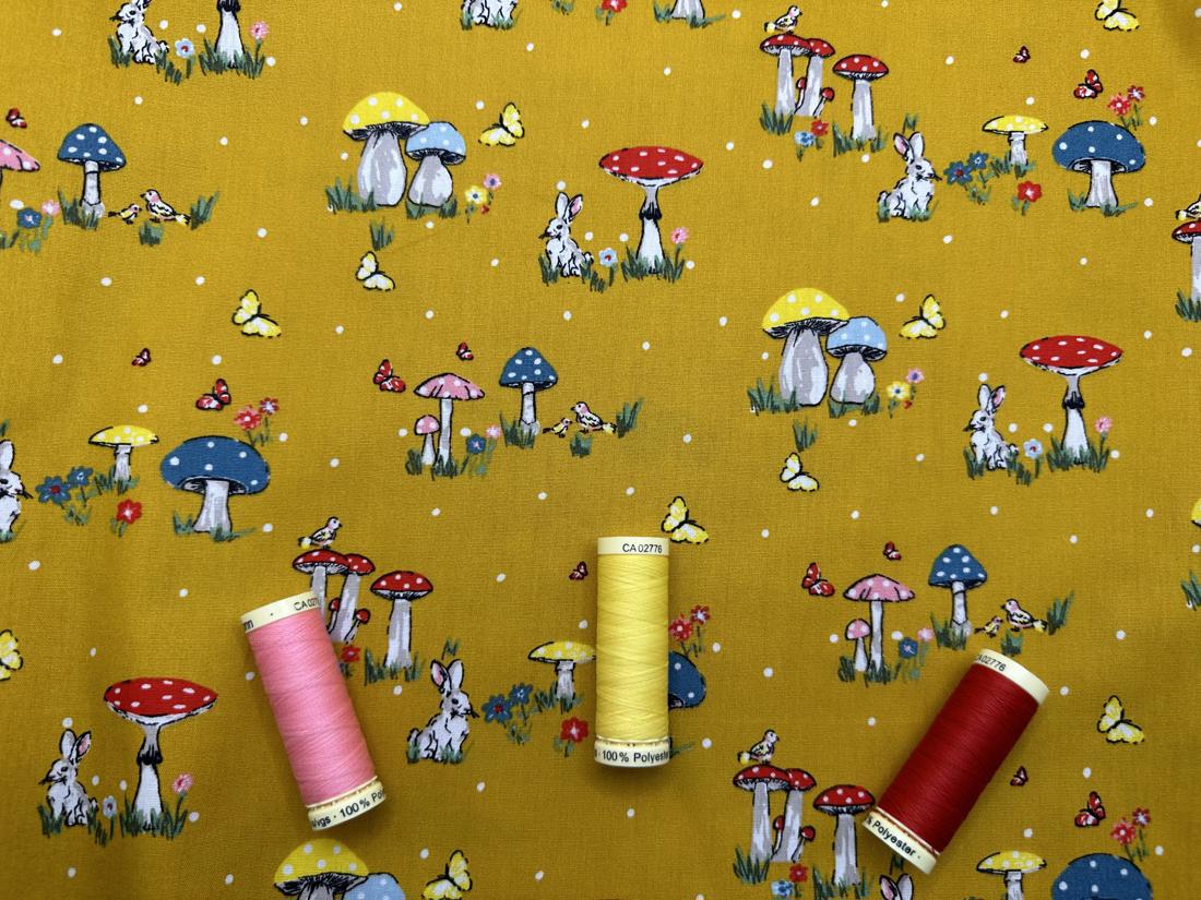 Rabbits Toadstools Butterflies & Birds on a Mustard Background 100% Cotton