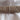 Rolled plain taupe 100% cotton fabric on white background, approx 150cm wide, suitable for crafts and sewing projects