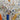 White cotton fabric with digital prints of school sports accessories including football, baseball, hockey, and other sports items in colorful illustrations