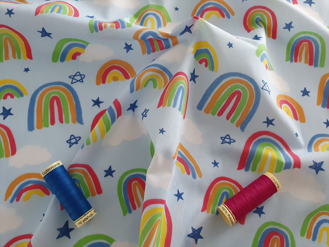 Bright Rainbows &amp; Clouds on a Sky Blue Background Poly Cotton