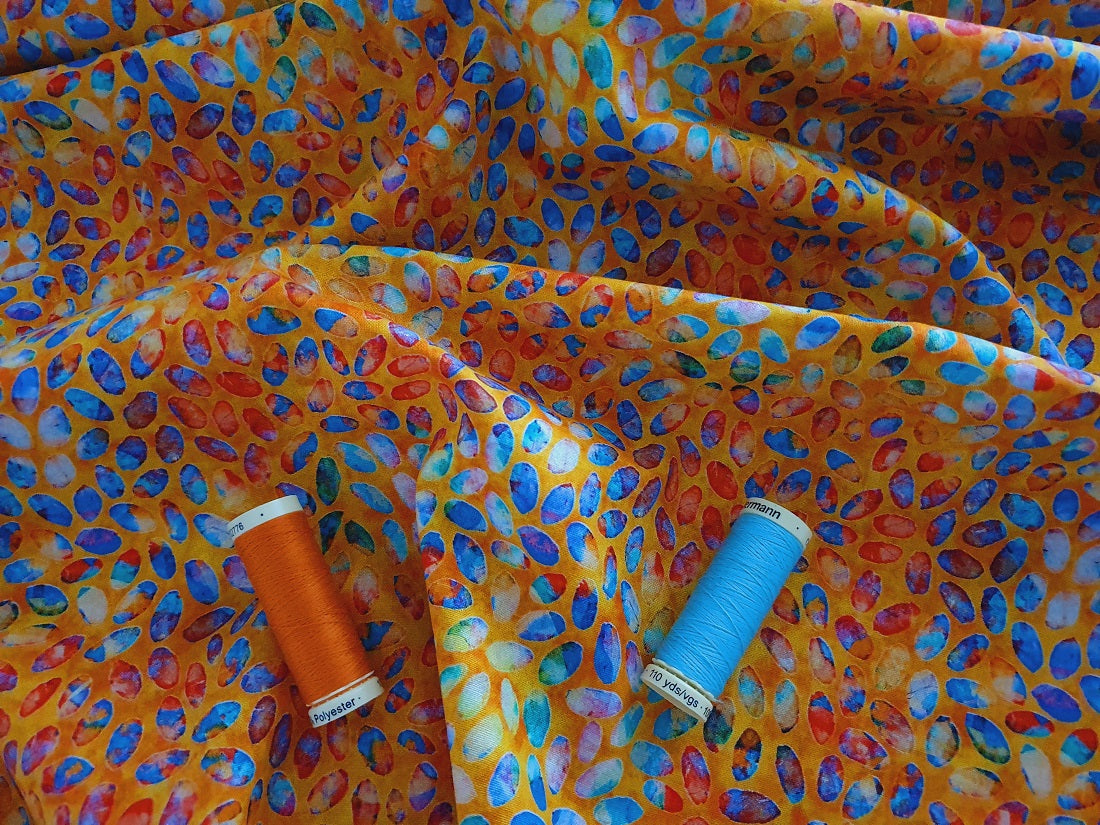 Quilting Treasures Colorful Scattered Petals on a Orange Background 100% Cotton