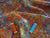 Quilting Treasures Colorful Scattered Petals on a Orange Background 100% Cotton