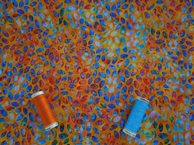 Quilting Treasures Colorful Scattered Petals on a Orange Background 100% Cotton
