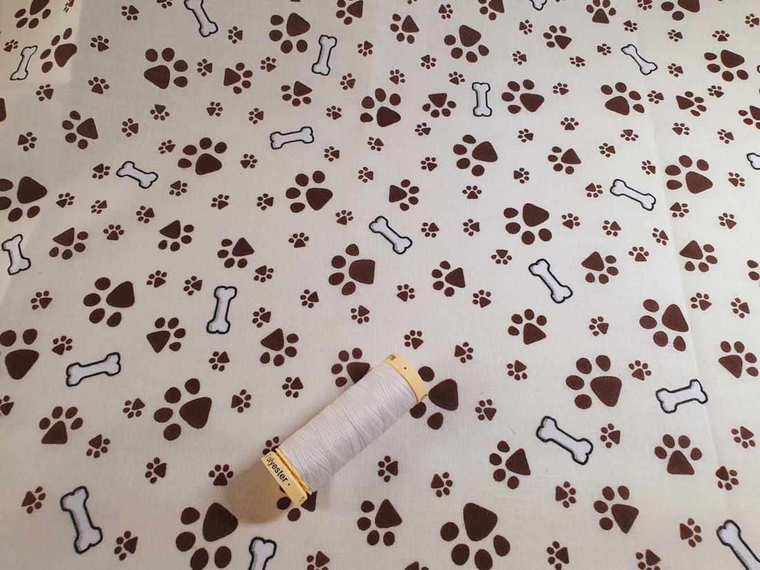 Dog Paws & Bones Brown on a Cream Background Poly Cotton