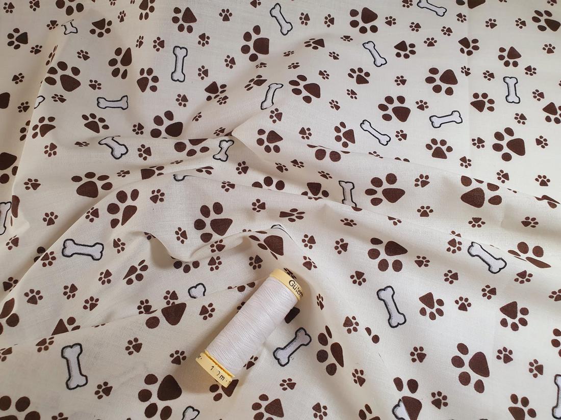 Dog Paws &amp; Bones Brown on a Cream Background Poly Cotton