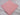 Folded plain candy pink poly cotton fabric piece on white fabric background