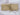Plain beige 100% cotton fabric rolled and tied with twine on white background