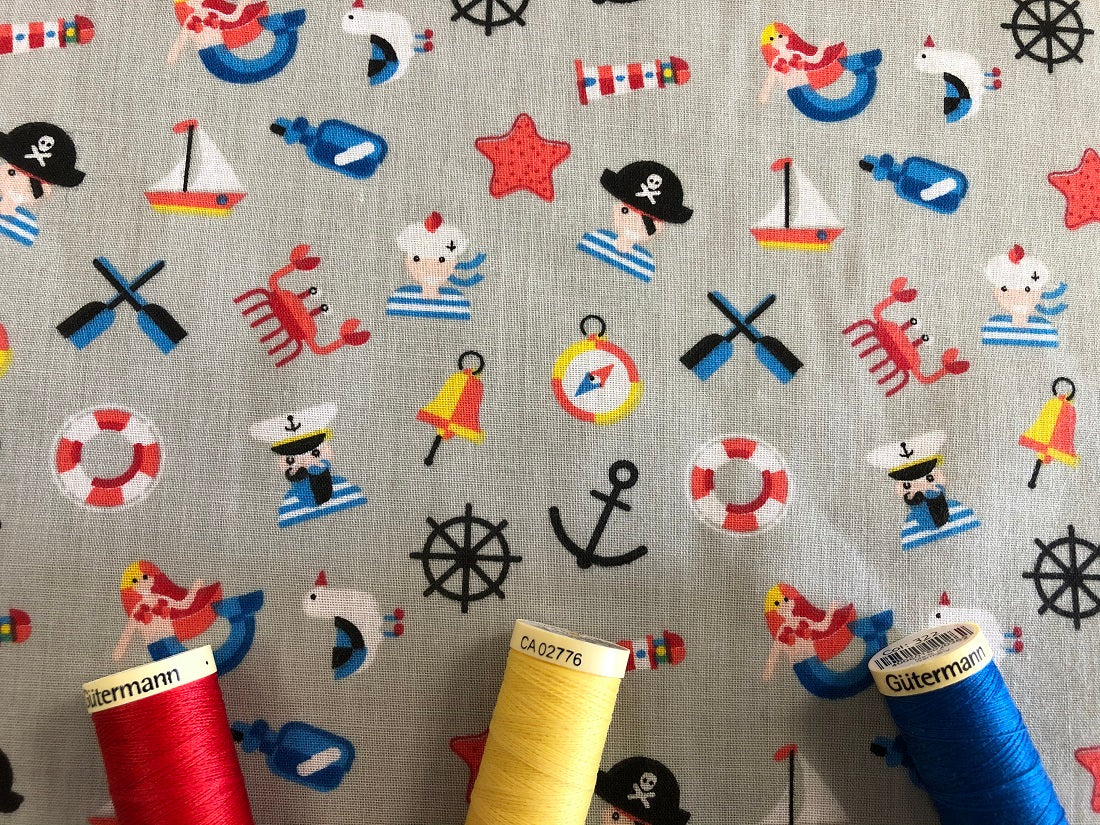 Pirates Mermaids & Nautical Notions on a Silver Grey Background Poly Cotton